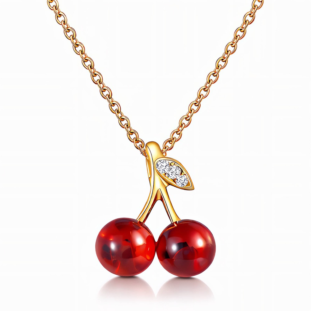 Goldfarbene Kette mit zwei roten Kirschen und einem Kristallblatt